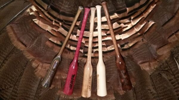 A bunch of wooden bats sitting in a basket