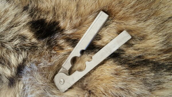 A pair of scissors sitting on top of a fur.