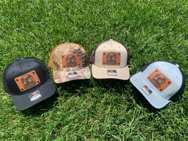 Four hats in a row on the grass