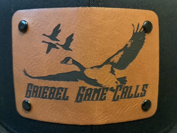 A leather plaque with the name of a game call.